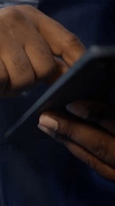 Vertical video Technician in server hub checking recovery plan on tablet, monitoring energy consumption across mainframes. Close up shot of man in data center making sure rigs are functioning