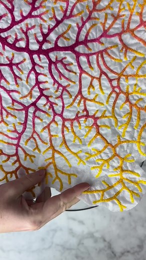 A new little coral fan embroidery. I love how this one seems to glow. This artwork was created using a freehand machine embroidery technique which allows me to draw with thread. The coral drawing is stitched onto water soluble fabric which you can see me removing in the first part of this video. Once the base fabric is dissolved I am left with my lace like thread drawing, my sculptural embroidery. A beautiful stitched coral specimen you can proudly display on your wall. This piece will now be mo