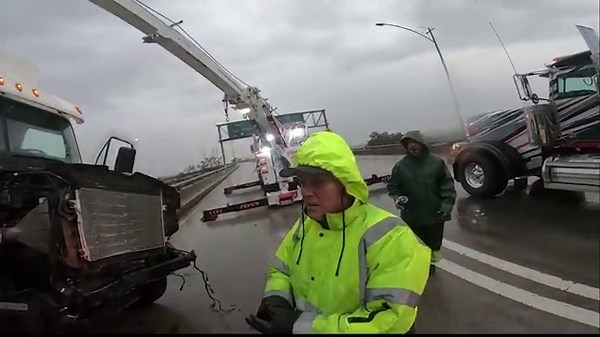 Big rig crashes and is left dangling off freeway bridge in Los Angeles!