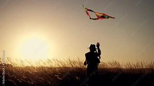 Happy girl playing with kite. Child run with toy on grass in park. Kite soars in wind. Girl with toy kite. Happy child run on grass. Kite in the wind in park. Girl playing in park