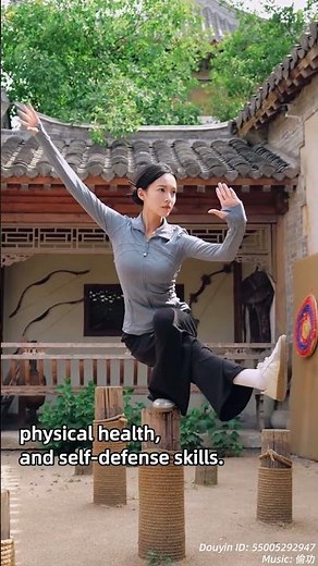 Woman performs Tai Chi, standing on one leg on a wooden pole
