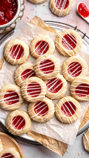 Sam Hu | Quick & Easy Recipes on Instagram: "Soft, buttery, and filled with sweet jam goodness 🍓✨ These JAM THUMBPRINT COOKIES are made with a tender shortbread dough, filled with your favorite fruity jam, and finished with a drizzle of almond glaze. They melt in your mouth, come together quickly, and don’t require any fancy equipment — making them perfect for holiday cookie platters, gifting, or an easy baking win any day of the week. 📝 Comment “RECIPE” and I’ll DM you the recipe or click the