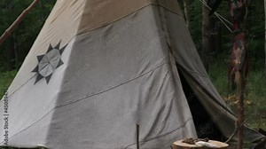 Forest home of the Indians. Wigwam indian teepee. The life of nomadic tribes. The wigwam stands in the forest. A hut of nomadic peoples. A home of Indians. tippi aka in the forest.