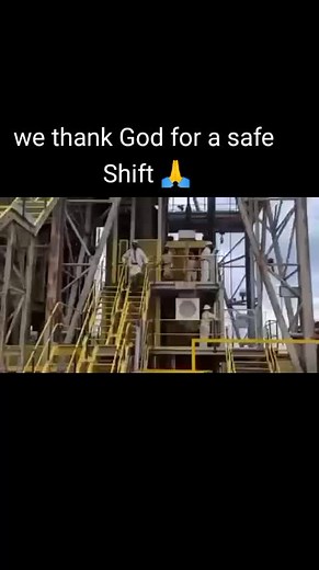 Workers in Protective Gear Ascend Industrial Staircase