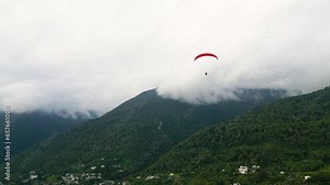 Paraglider Flying Over Mountains in Abkhazia. Extreme and active rest. Drone view