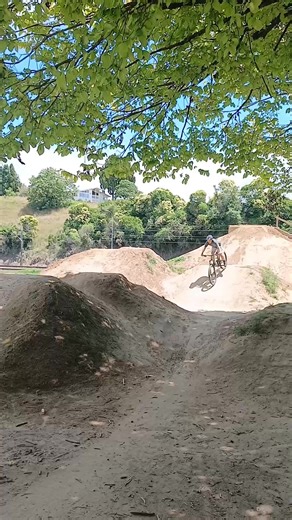 Exploring Dirt Jumps at the Skatepark with Friends