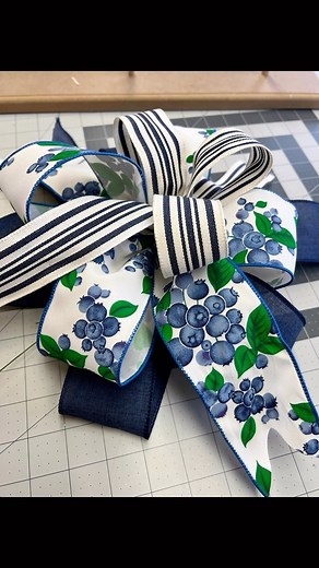 Let’s get your bows done for your deco mesh wreaths. You can make one by hand or use an E-Z Bowmaker like I am. Make one 8” ribbon tail, four 6” bow loops and one 8” ribbon tail with the 2-1/2” ribbons. Then one 6” ribbon tail and three 5” bow loops and one more 6” ribbon tail with the 1-1/2” ribbon. Secure the middle with florist wire or a chenille stem. Then arrange and fluff your bow loops. Don’t forget to dovetail your ribbon tails. Now your bow is ready to attach to your wreath. . . #bowmak