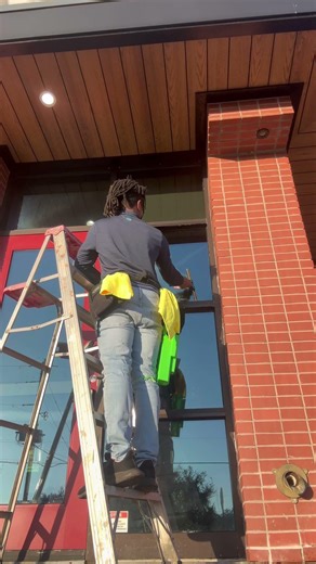 Ladder cleaning storefront windows. #windowcleaning