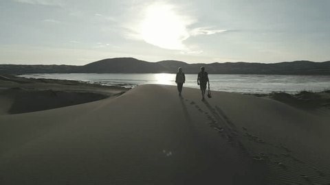 clip-4000399349-aerial-view-two-travelers-backpacks-walking-on