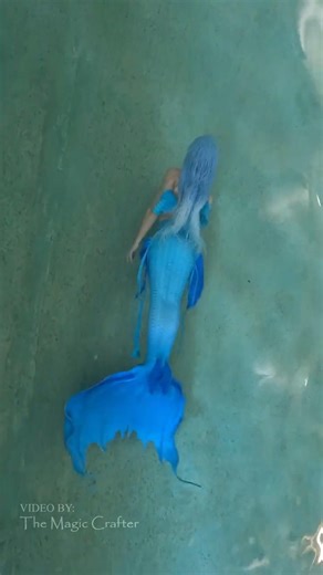 A blue mermaid in a pool