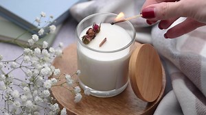 Hand lighting candle with matchstick