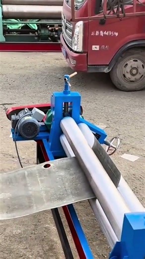 operating a high precision metal rolling machine to shape large industrial sheets into perfect