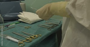 The nurse assistant prepares medical instruments , devices before surgery. Equipment, Instruments, Sterilize.