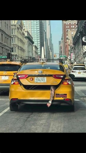 Yeat arm is hanging out of taxi cab with the caption