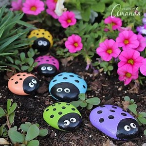 DIY ladybug garden stones!!! These are adorable. Get the instructions --> https://craftsbyamanda.com/ladybug-painted-rocks/ | Lemons and Laser Beams