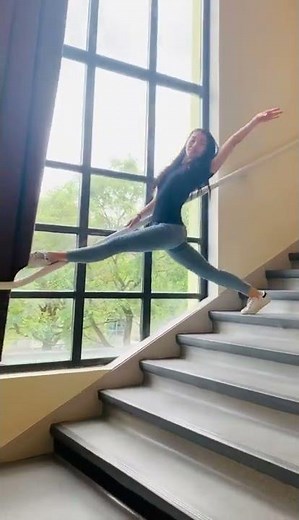 Contortionist Performs Split Gymnastics While Walking Down Stairs-1343136