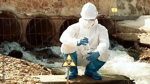 Ecologists sample water contaminated with dangerous, waterhazard toxins into tubes, Scientist or Biologist in protective waste water from industrial for analyze, problem environment, Testing toxic.