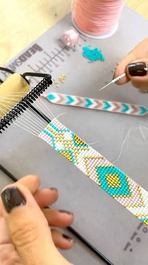 Lilith Bead Studio on Instagram: "🎯 Bead Loom Weaving Technique – Behind the Process In loom beading, precision is key. Each bead is carefully placed between warp threads, then secured by threading the needle back through the beads above the warp. 🔸 The featured pattern combines metallic gold, white, blush pink, and turquoise — creating a balance of elegance and vibrance. 🔸 Mastering this method requires consistent thread tension, a steady hand, and close attention to detail. 🔸 Tools used: B