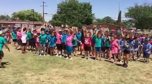 Hobbs firefighter Tanner Ingley and Fire Captain Adrian Enriquez spray down Broadmoor Elementary students Tuesday at the school. | Hobbs News-Sun