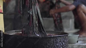 Close Up, a Man Was Dying the Fabric for Batik Process in a Traditional Stove