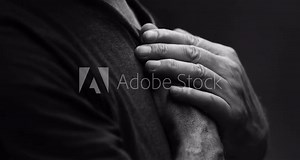 Heartfelt Senior Man with Hands on Chest in Quiet Reflection, Feeling Grateful in God's Grace in dramatic black and white