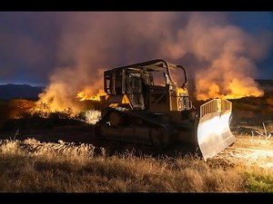Wildland Fire, Fire Fighters, a Dozer and Aircraft work to stop it.