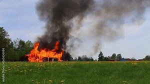 Dark smoke over a forest due to wildfires with emergency fire vehicles of the German fire services
