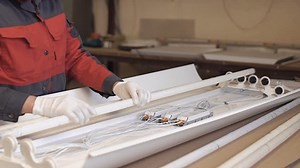 Lamps to assemble. Assembly of industrial lighting fixtures at factory