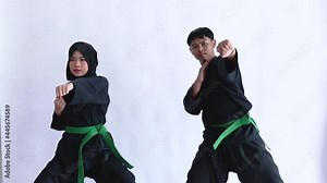 Asian men and women wearing pencak silat uniforms fight on the isolated background