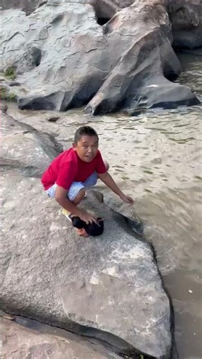 Child washing their clothes.