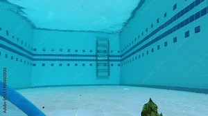 Cleaning the pool with a skimmer net. Underwater POV shooting of the pool. Pool maintenance process. The skimmer net captures fallen leaves and debris from the pool