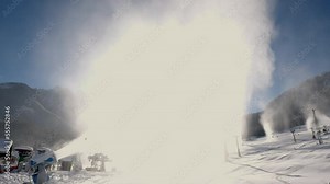 Snowmaking machine snow cannon or gun in action on a cold sunny winter day in ski resort Kranjska Gora, Slovenia.