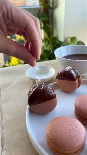 Maddie Brehm on Instagram: "Let’s make some caramelized vanilla & chocolate macarons! These macarons have a caramel vanilla custard ganache with a cocoa milk jam, and are dipped in chocolate and topped with some flaky sea salt. They are fun to make, delicious, and sure to be loved by anyone you share them with! You can find this recipe and tutorial as an individual recipe and in my Milestone Macarons ebook on my website 👩🏻‍🍳"