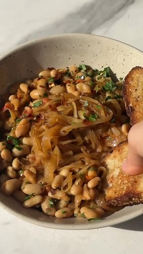 Melissa Clark's Rosemary White Beans With Frizzled Onions and Tomato: https://nyti.ms/4iLOLXH | NYT Cooking