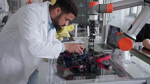 Robotic Engineer Working on Mechanical System of Robotic Arm Electrical Engineering Concept of