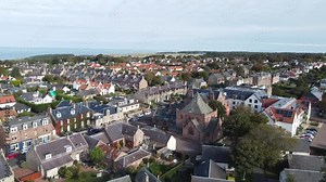 Gullane. Flight over the Scottish town. Gullane is a town on the southern shore of the Firth of Forth in East Lothian on the east coast of Scotland