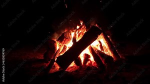 Night Bonfire Burns in the Dark Forest - Isolated on Black Background. Flaming Campfire at Nighttime. Place for Bonfire. Fire Pit Outdoors, Wood on Fire, Flying Sparks and Smoke - Static Shot