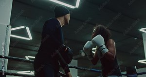 professional african fighter is practicing defensive and attack with coach in fight club, 4K, Prores