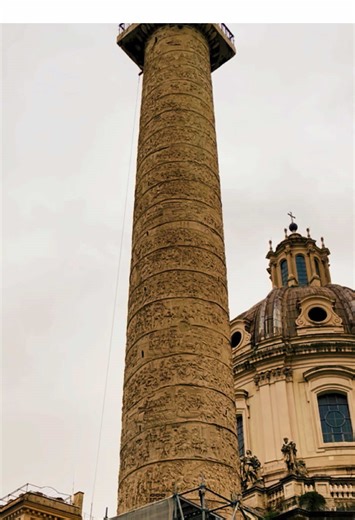 Trajan’s Column is a monumental structure in Rome, built in 113 CE to commemorate Emperor Trajan’s victories in the Dacian Wars (101–102 and 105–106 CE). It is one of the most remarkable examples of Roman triumphal art and serves as both a historical record and a celebration of Roman engineering and military might. Key Features of Trajan’s Column: \t1.\tDesign: \t•\tThe column is 35 meters (115 feet) tall, including its base, and consists of 20 colossal marble drums. \t•\tA spiral relief winds a