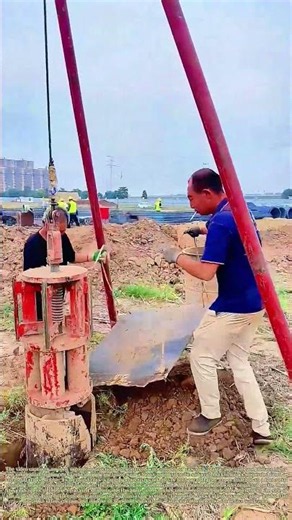 Claw Bucket Drilling: Two Laborers Guide Piling Rig To Lift And Dump Excavated Soil