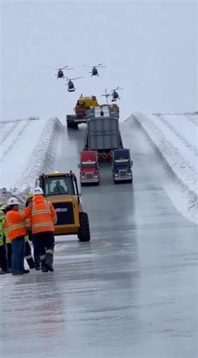 Semi trucks hauling over sized load slides down icy hill