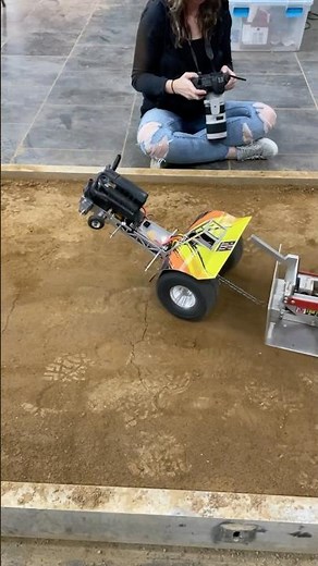 Scratch built modified RC tractors pulling a heavy sled at the Worlds
