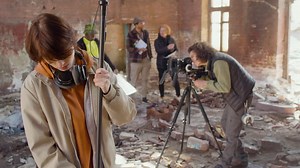 Free stock video - Two production co workers getting ready to record in a ruined building 1