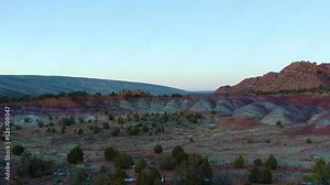 Hidden rainbow mountains lodged in red rock canyons, far back pushing aerial drone view. Candy valley archeology layers. Shot on 4k DJI Mavic 2 Pro. Rainbow Valley, Arizona United States