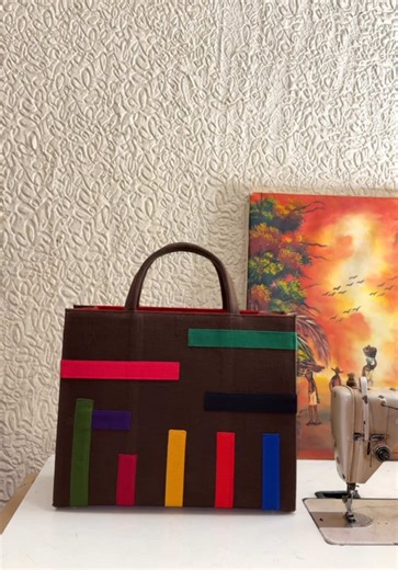 HAMDALA, COLOUR BROWN, LINE PATTERN MAXI, MIDI, MINI We have finally restocked the Hamdala Bag and each one is made with love, using full plain Aso Oke and thoughtfully designed to carry your essentials with elegance. From workdays to travel days, this is the bag you can truly rely on. Available in three sizes: Maxi – Fits up to a 16” laptop Midi – Fits up to a 14” laptop Mini - Fits a Tab Same features. Same elegance. Just different sizes. Key Features: ✔️ Maxi and Midi comes Padded Adire lapto