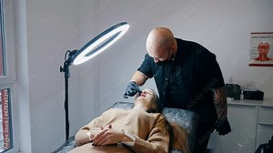 The result of lip augmentation. The injection doctor moisturizes large lip enlargements after surgery. lip augmentation procedure. beauty injections. Plastic surgery.