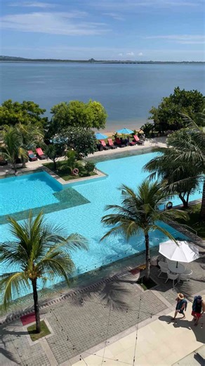 Balcony Views of a Tropical Beach Resort and Sparkling Pool