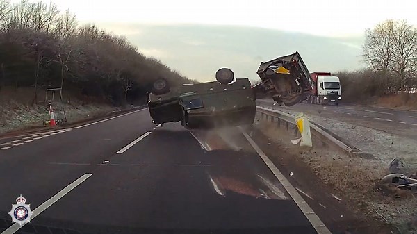Horror moment military vehicle crashes and flips after being cut up by idiot driver