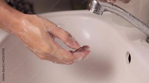Closeup view of a woman washing hands in the bathroom. The concept of cleanliness and hygienic routine. Hygiene always comes first