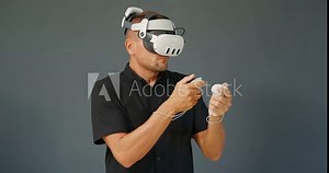 Man experiencing virtual or mixed reality in modern VR goggles.